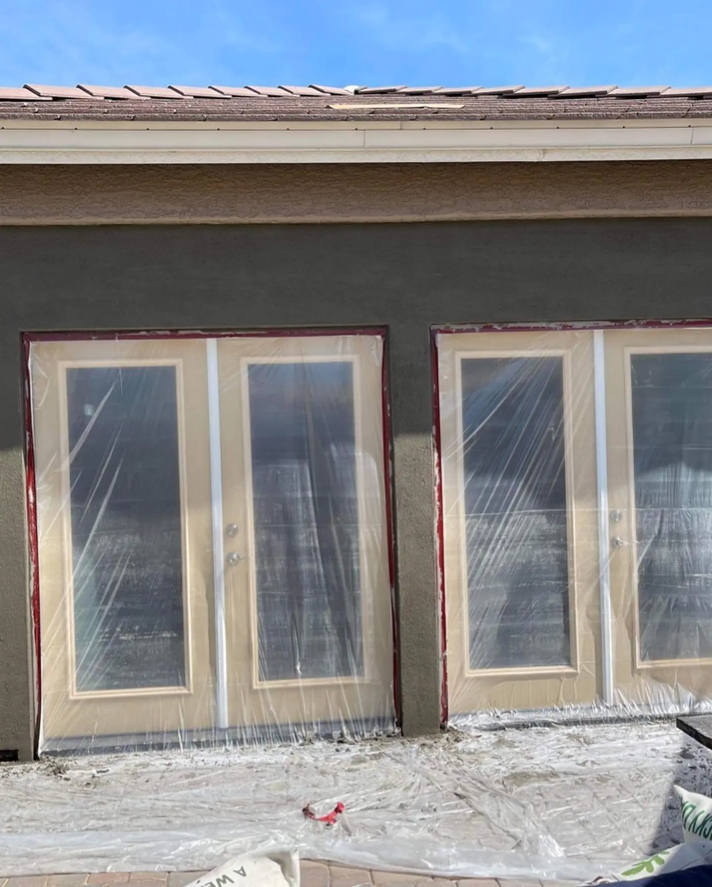 Exterior repaint preparation with masked French doors