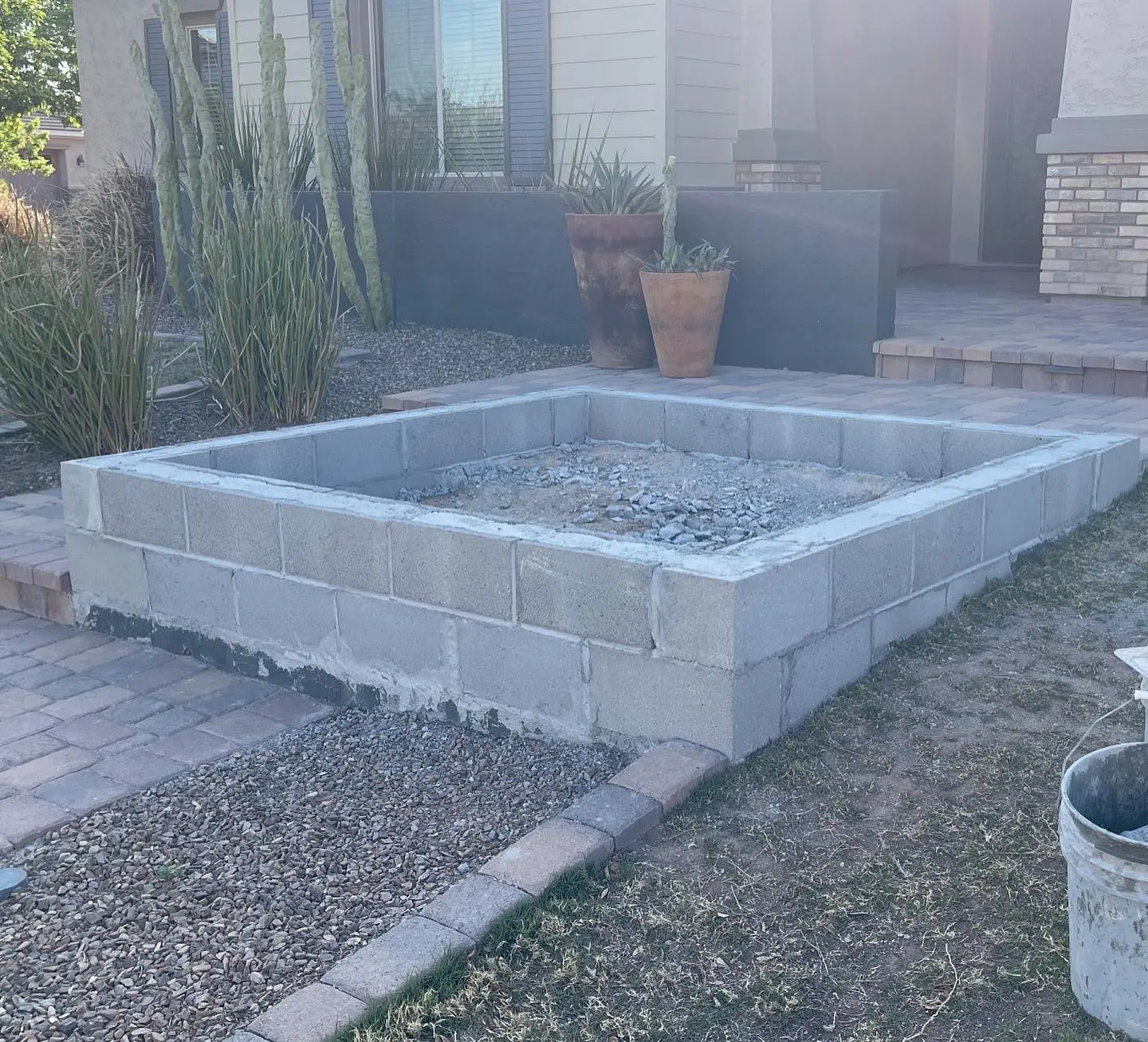 Block-and-concrete planter structure with paver surround